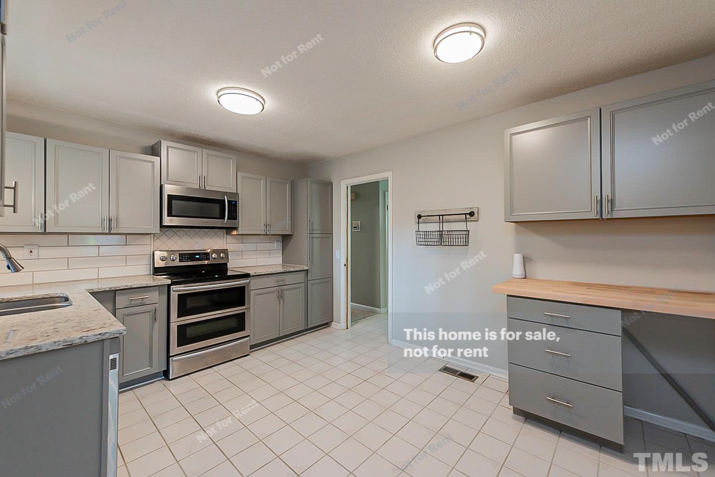 1338 Sedwick Road Durham, NC 27713 - Photo 6 of 20 a kitchen with stainless steel appliances granite countertop a refrigerator and a stove top oven