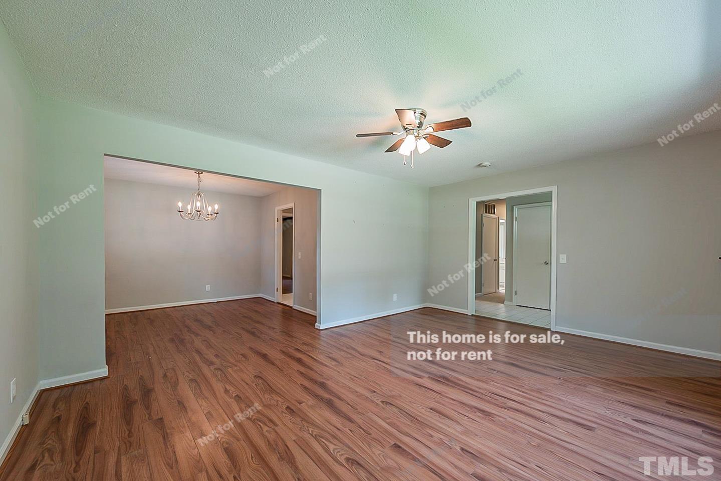 1338 Sedwick Road Durham, NC 27713 - Photo 8 of 20 a view of an empty room with wooden floor and a window
