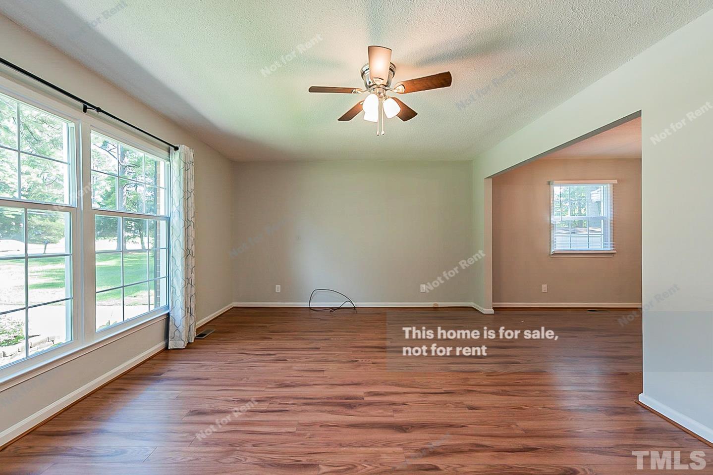 1338 Sedwick Road Durham, NC 27713 - Photo 9 of 20 a view of an empty room with window and wooden floor