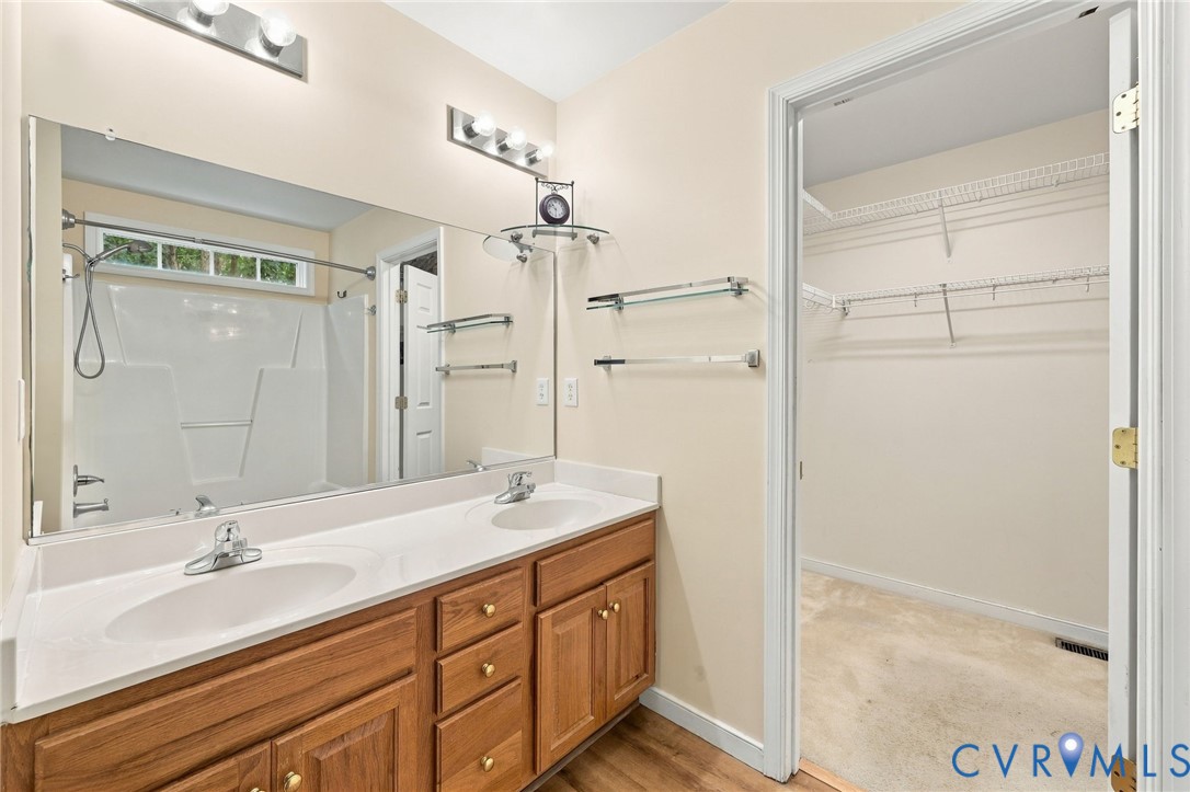 244 East Huntsman Road Sandston, VA 23150 - Photo 28 of 54 Dual vanity with wood-finish cabinetry, a large wa