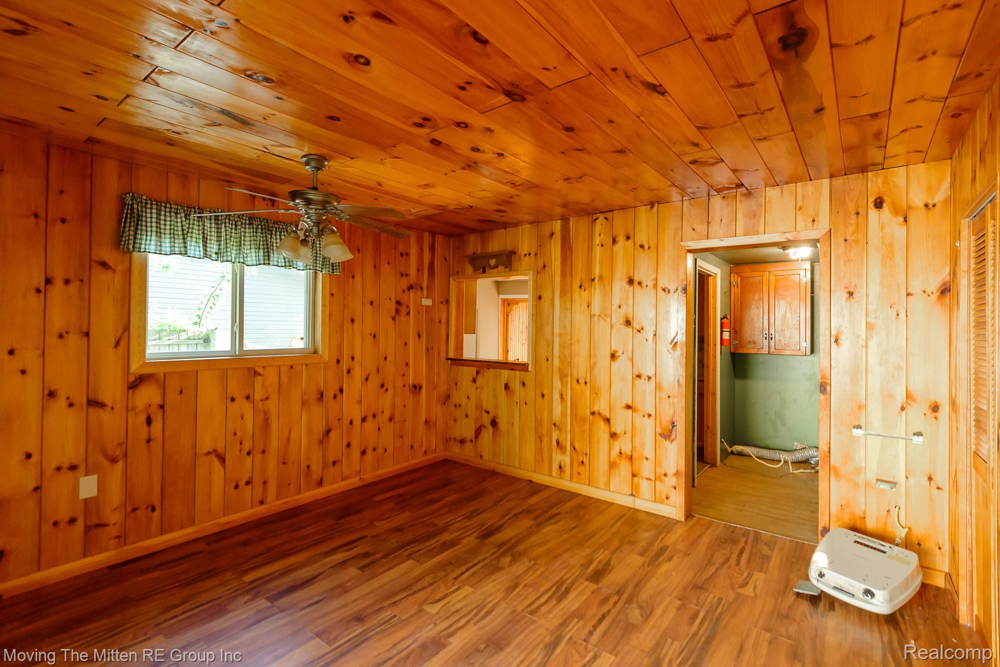 26247 Weigel Road New Boston, MI 48164 - Photo 13 of 30 Wood-panel walls and ceiling with wood-finish flooring