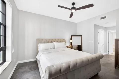 a bedroom with a bed and a ceiling fan