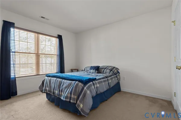 a living room with furniture and a ceiling fan