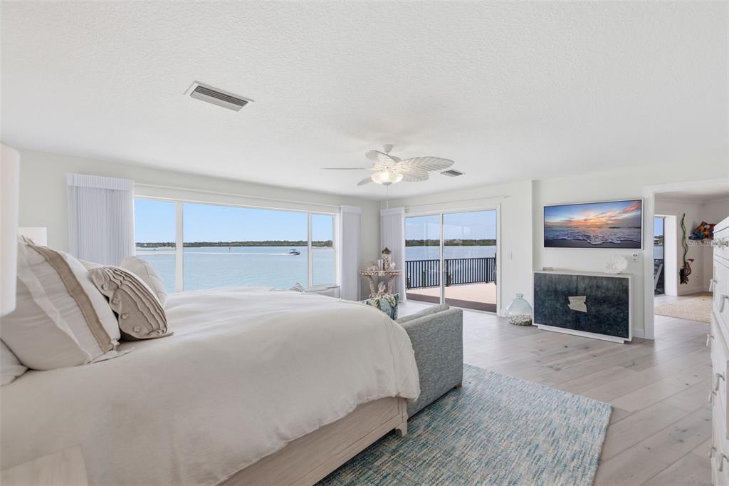 16123 6th Street East Redington Beach, FL 33708 - Photo 16 of 48 a bedroom with a large bed and a fireplace