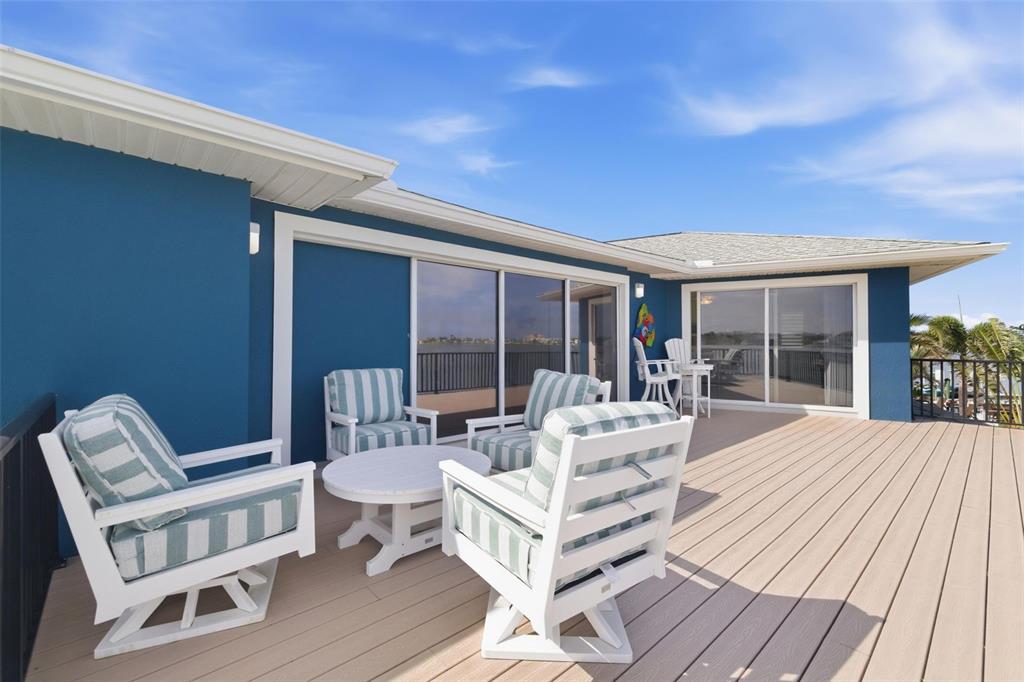 16123 6th Street East Redington Beach, FL 33708 - Photo 22 of 48 a building outdoor space with patio furniture and potted plants