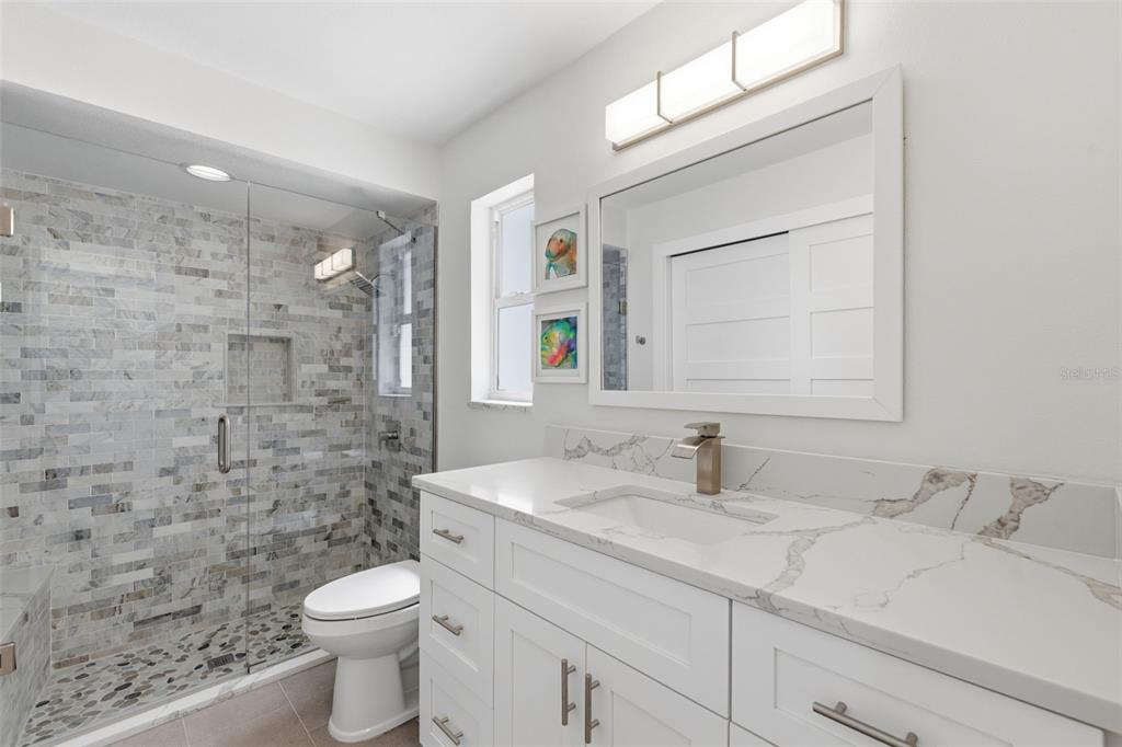 16123 6th Street East Redington Beach, FL 33708 - Photo 28 of 48 a bathroom with a sink a toilet and shower