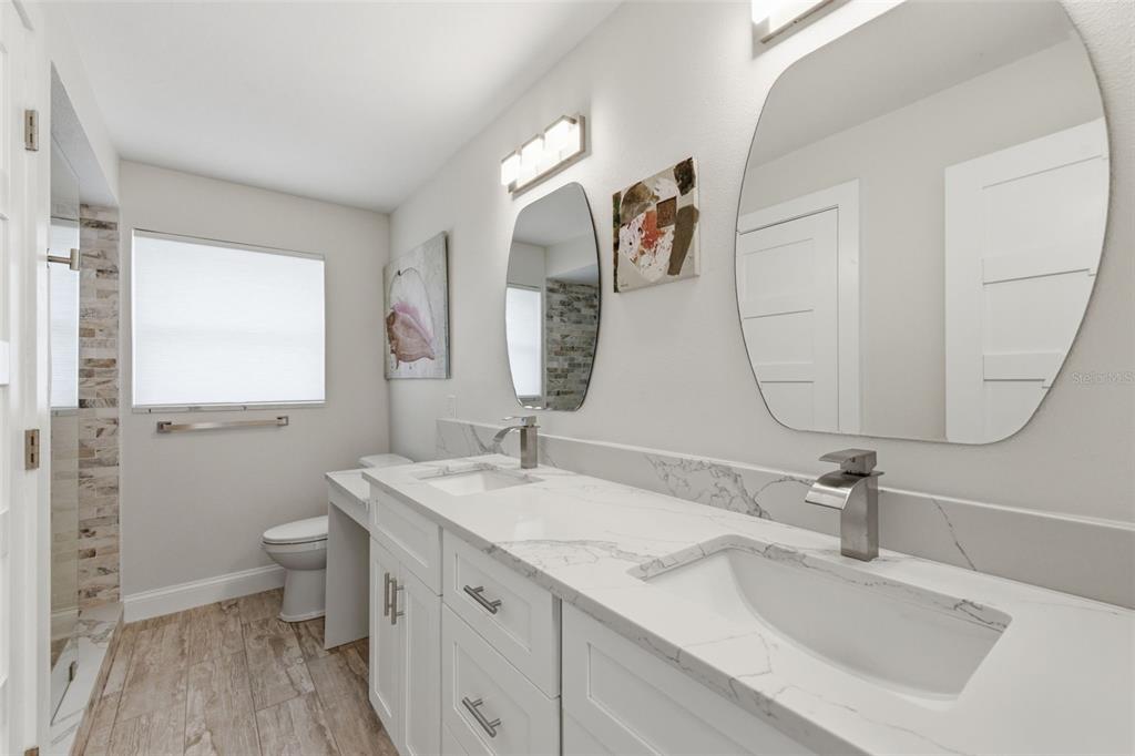 16123 6th Street East Redington Beach, FL 33708 - Photo 29 of 48 a bathroom with a double vanity sink and a mirror