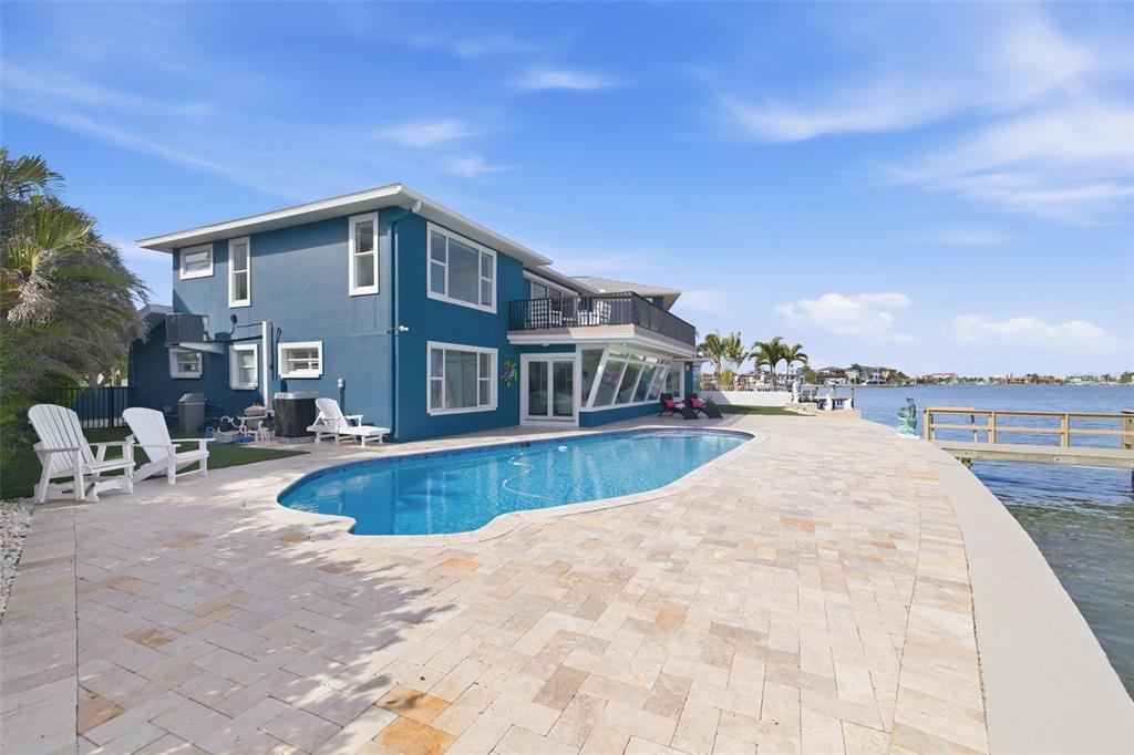 16123 6th Street East Redington Beach, FL 33708 - Photo 33 of 48 a view of a house with swimming pool and sitting area