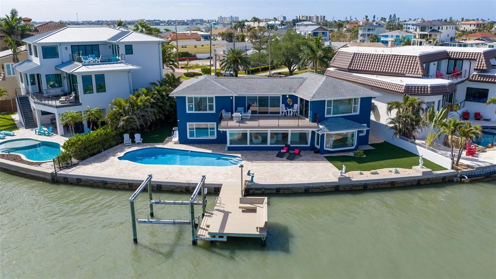 16123 6th Street East Redington Beach, FL 33708 - Photo 4 of 48 a aerial view of a house with swimming pool and a yard