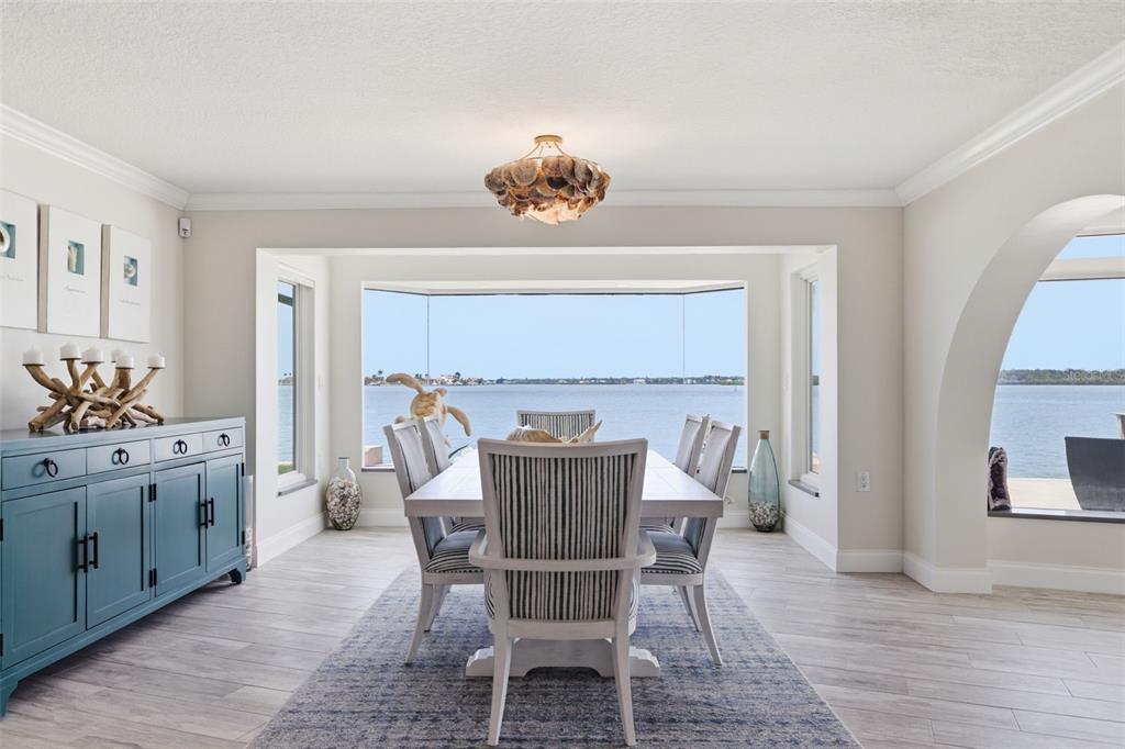 16123 6th Street East Redington Beach, FL 33708 - Photo 9 of 48 a view of a dining room with furniture window and wooden floor