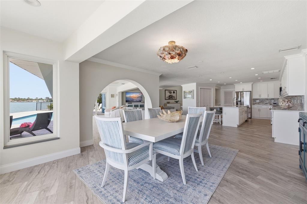 16123 6th Street East Redington Beach, FL 33708 - Photo 10 of 48 a view of a dining room and livingroom with furniture a chandelier and wooden floor