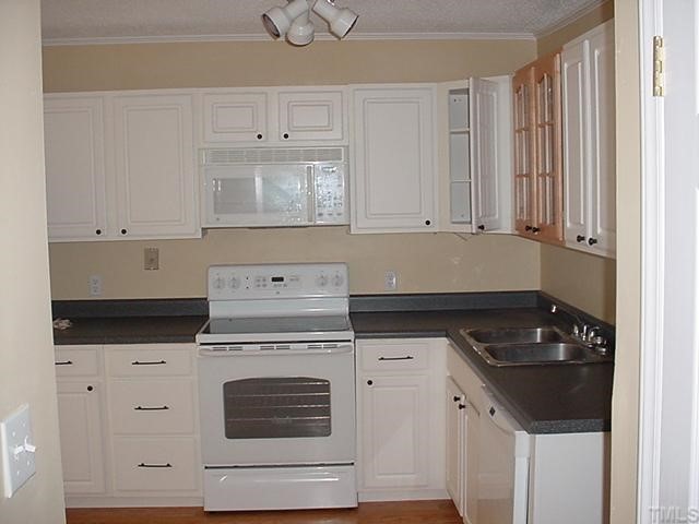 645 Bashford Road Raleigh, NC 27606 - Photo 6 of 8 a kitchen with granite countertop white cabinets and white stove