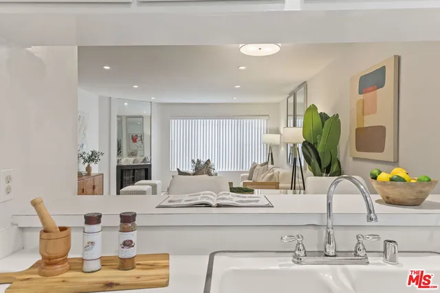 a kitchen with kitchen island granite countertop a sink and cabinets