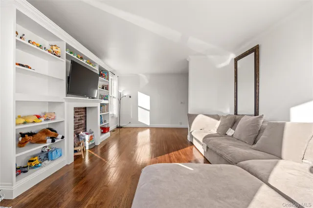 a living room with fireplace furniture and a flat screen tv