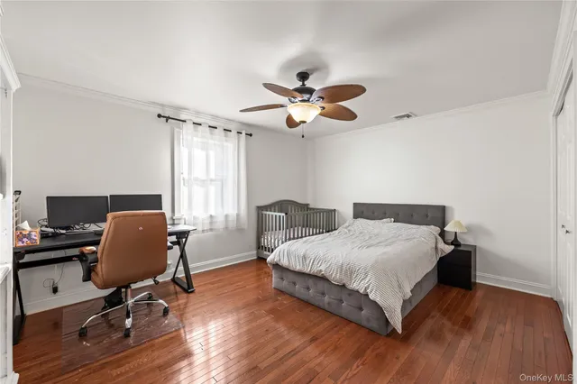 a bedroom with a bed window and a desk