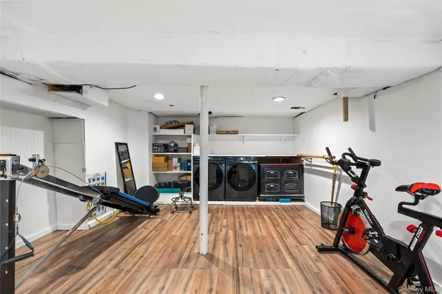 a view of a room with gym equipment and wooden floor