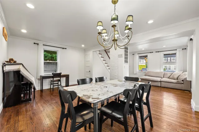 a view of a dining room with furniture wooden floor and chandelier