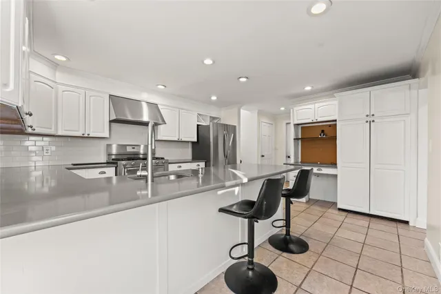 a kitchen with stainless steel appliances kitchen island granite countertop a sink and cabinets