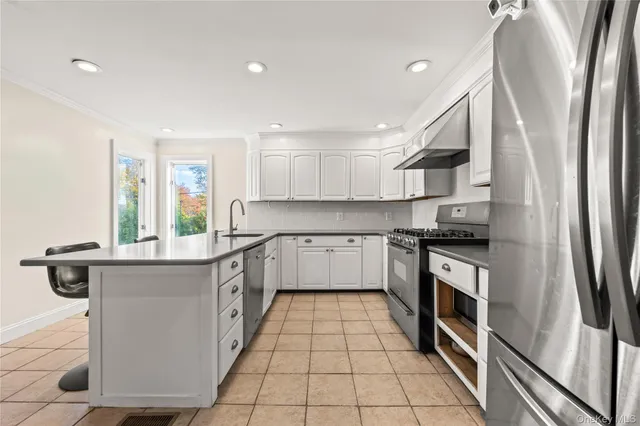 a kitchen with stainless steel appliances granite countertop a sink and a stove