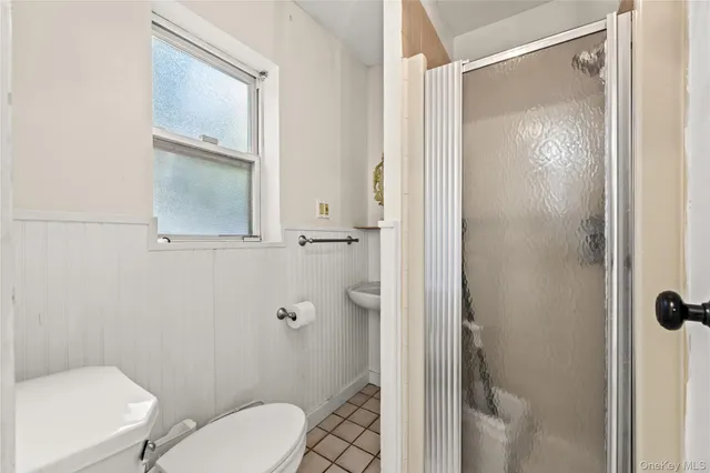a white toilet sitting next to a bathroom sink