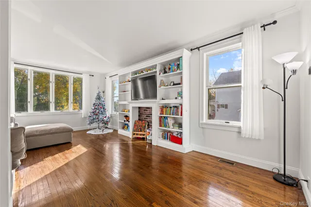 a living room with furniture window and wooden floor