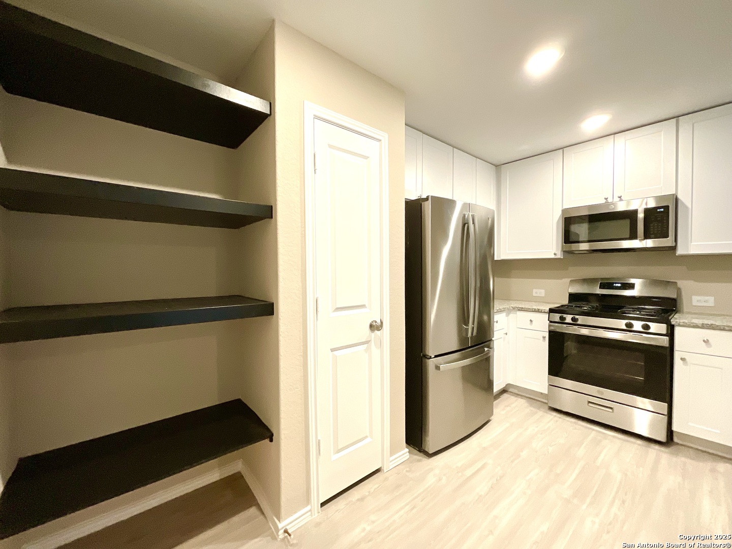 10751 Margarita Loop Converse, TX 78109 - Photo 17 of 40 a kitchen with stainless steel appliances a refrigerator and a stove top oven