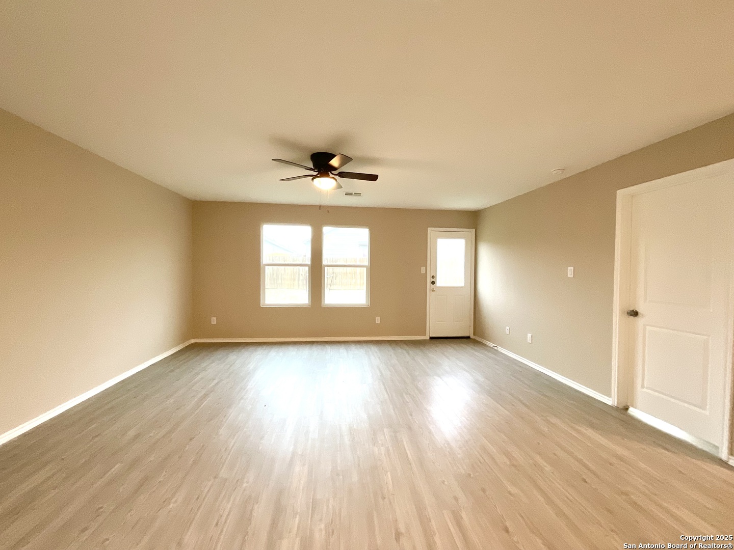 10751 Margarita Loop Converse, TX 78109 - Photo 22 of 40 an empty room with wooden floor and windows