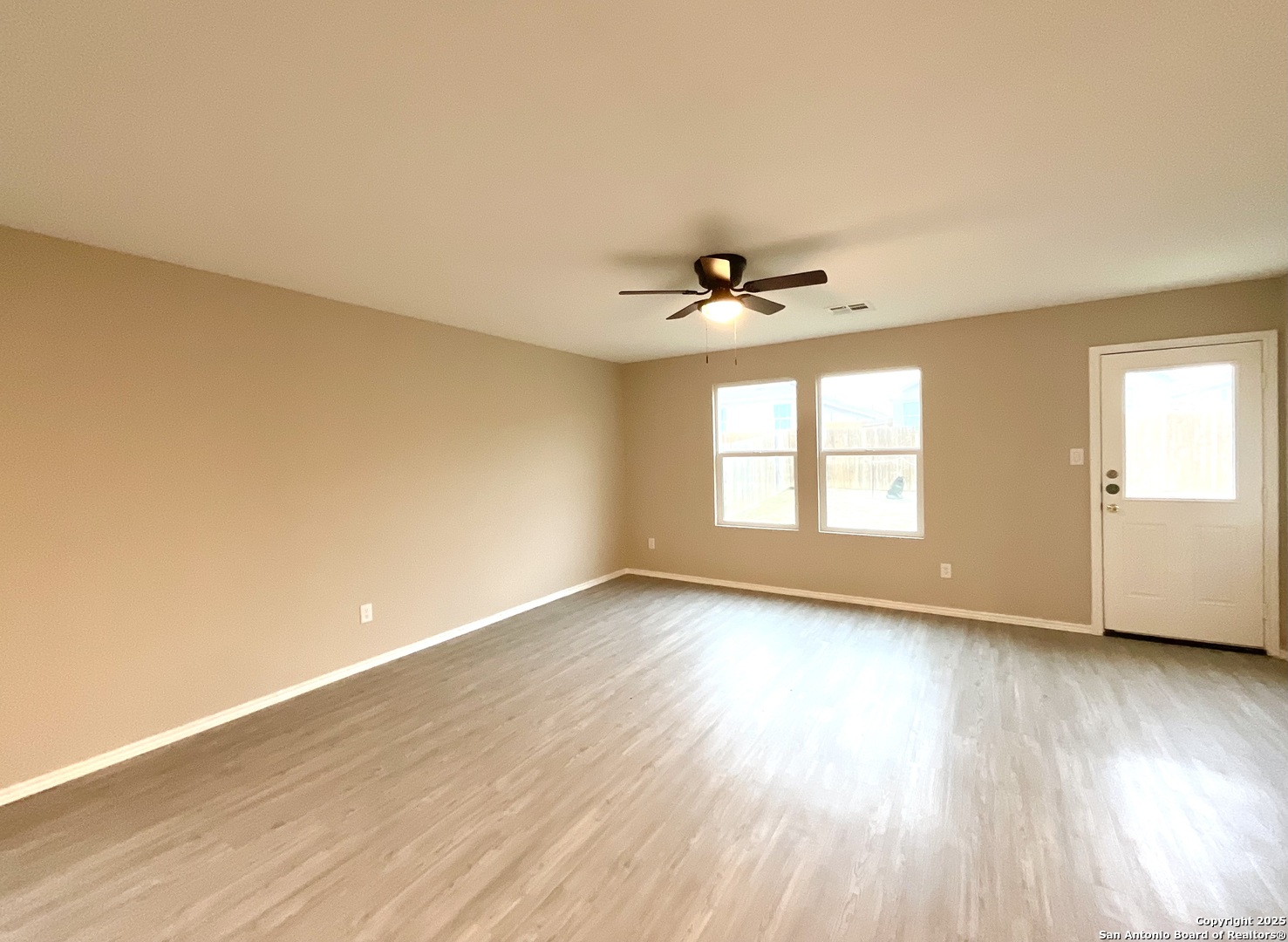 10751 Margarita Loop Converse, TX 78109 - Photo 23 of 40 a view of an empty room with wooden floor and a window