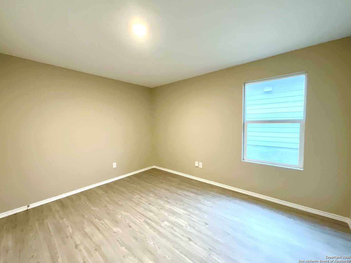 10751 Margarita Loop Converse, TX 78109 - Photo 5 of 40 an empty room with wooden floor and windows