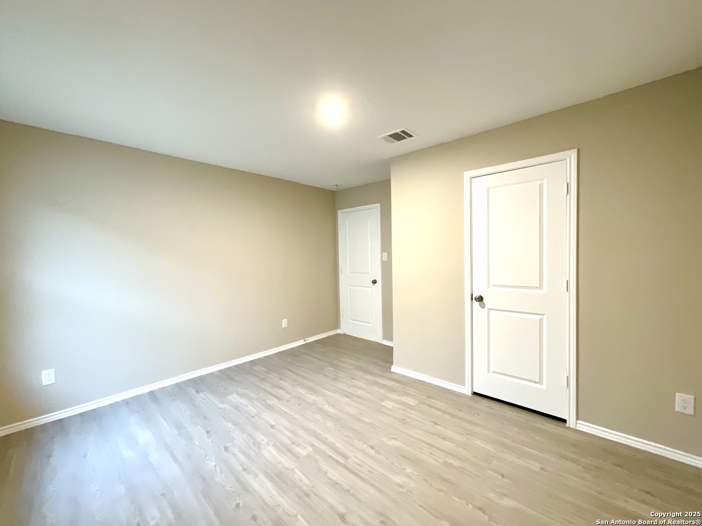 10751 Margarita Loop Converse, TX 78109 - Photo 7 of 40 an empty room with wooden floor and windows