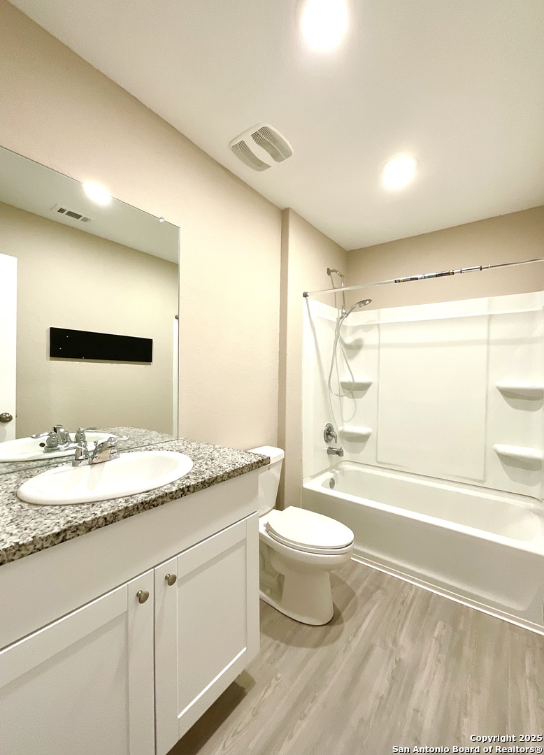 10751 Margarita Loop Converse, TX 78109 - Photo 8 of 40 a bathroom with a granite countertop sink toilet mirror and bathtub