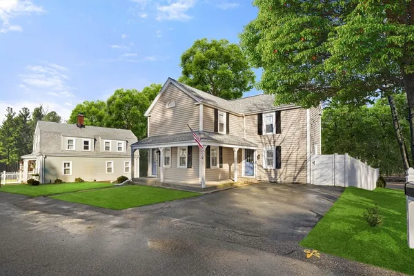 a front view of a house with a garden and yard