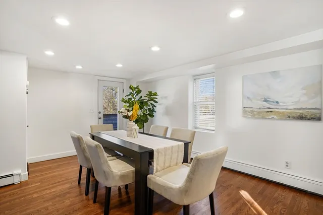 a view of a dining room with furniture and wooden floor