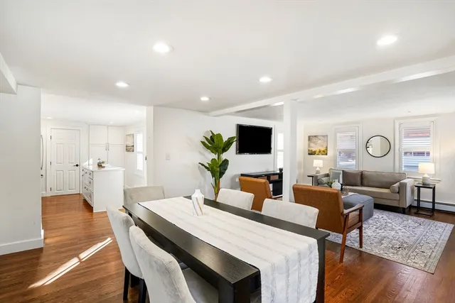 a living room with furniture wooden floor and a large window