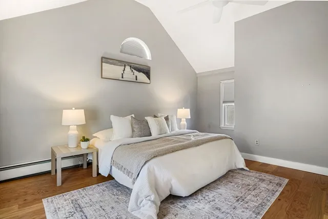 a bed room with a bed and a painting on the wall