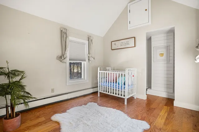a view of a livingroom with wooden floor and door