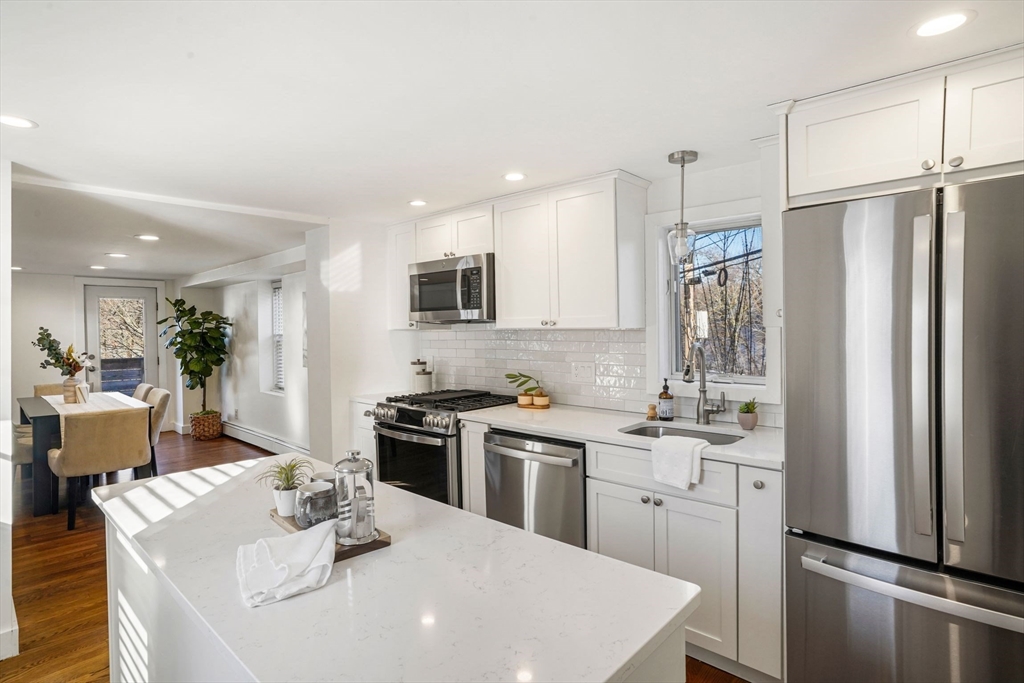 12 Sassamon Street Canton, MA 02021 - Photo 2 of 38 a kitchen with stainless steel appliances a sink stove refrigerator and cabinets