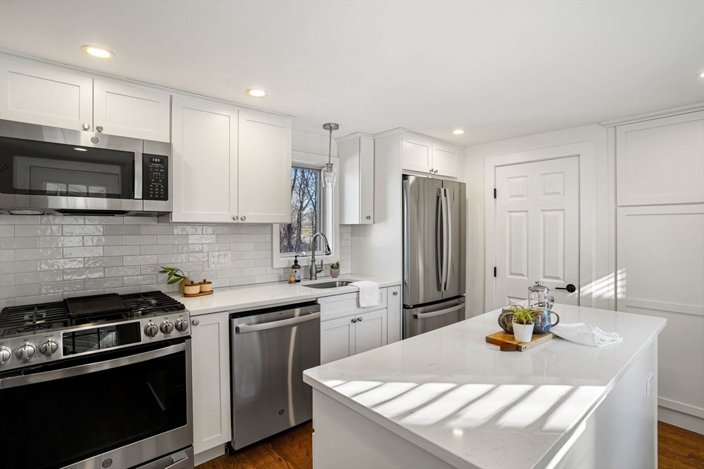 12 Sassamon Street Canton, MA 02021 - Photo 3 of 38 a kitchen with stainless steel appliances a stove a sink a microwave a refrigerator and cabinets