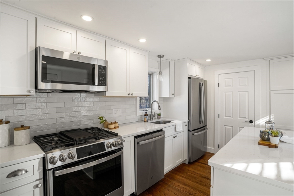 12 Sassamon Street Canton, MA 02021 - Photo 4 of 38 a kitchen with stainless steel appliances a stove a sink a microwave and cabinets