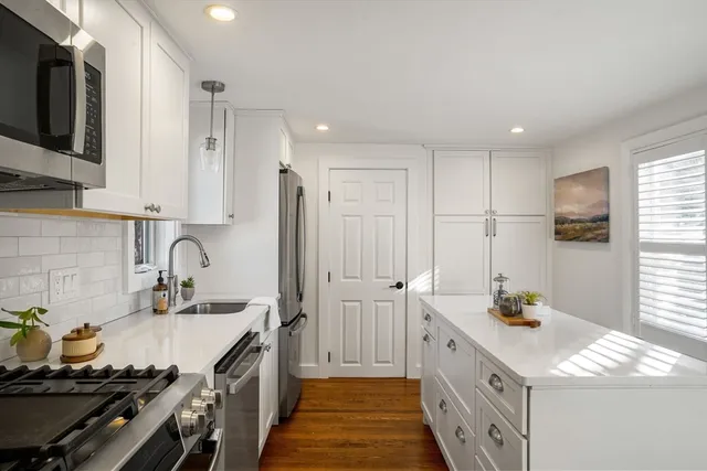 a kitchen with a sink stove and refrigerator