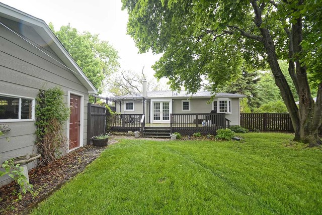 318 Village Road Willowbrook, IL 60527 - Photo 2 of 23 a front view of house with a garden and trees