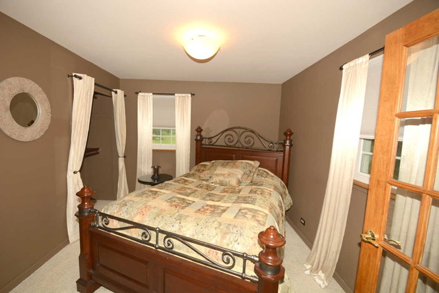 318 Village Road Willowbrook, IL 60527 - Photo 12 of 23 a bedroom with a bed and a window