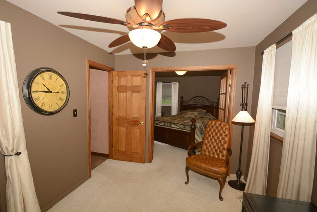 318 Village Road Willowbrook, IL 60527 - Photo 13 of 23 a living room with furniture a chandelier fan and a window