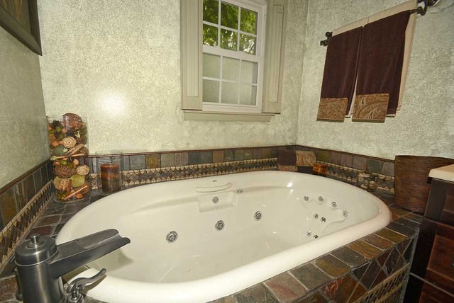 318 Village Road Willowbrook, IL 60527 - Photo 16 of 23 a bathroom with a tub and a sink