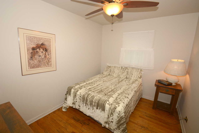 318 Village Road Willowbrook, IL 60527 - Photo 17 of 23 a bedroom with a bed and a lamp on table