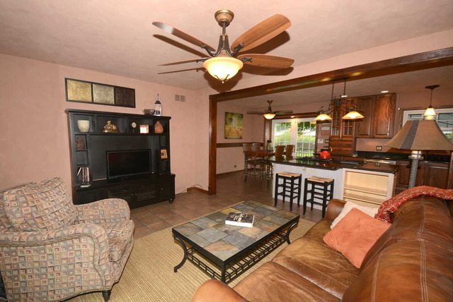 318 Village Road Willowbrook, IL 60527 - Photo 8 of 23 a living room with furniture a large window and a fireplace