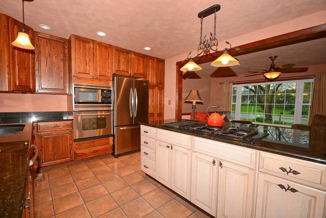 318 Village Road Willowbrook, IL 60527 - Photo 9 of 23 a kitchen with stainless steel appliances granite countertop a refrigerator and a sink
