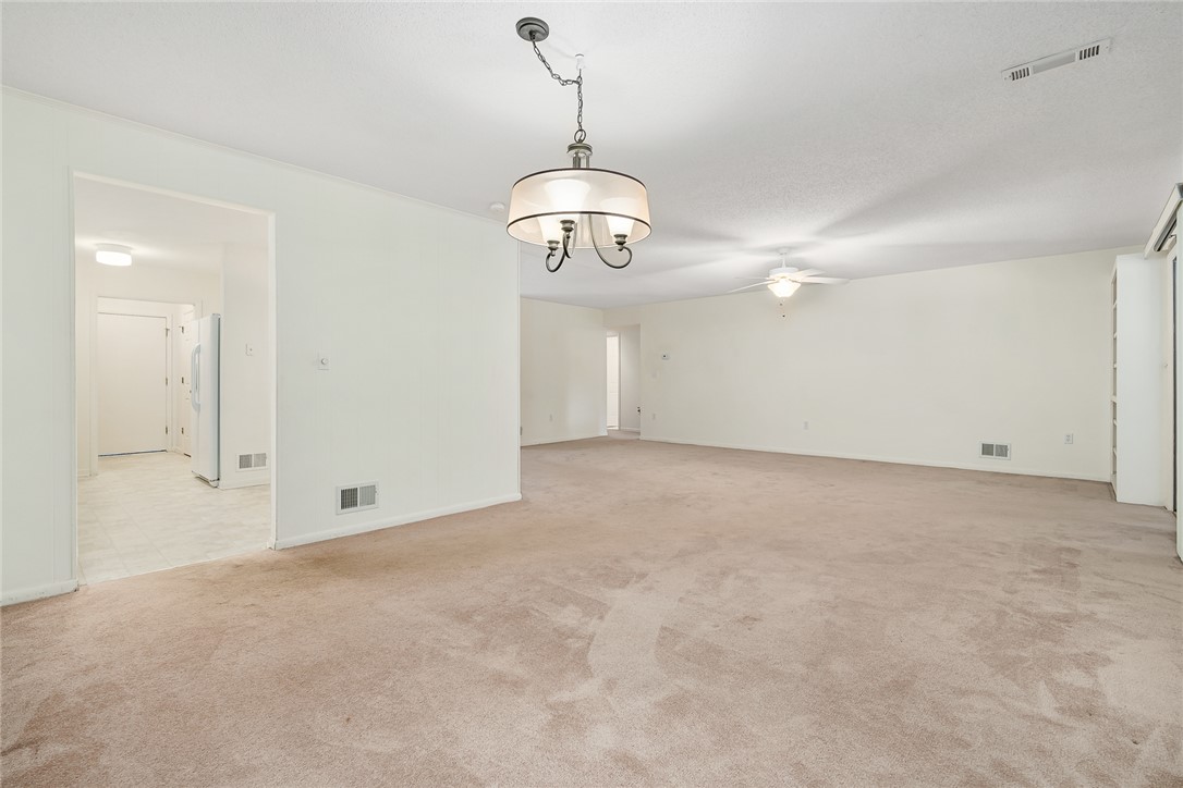 34 Hickory Way Clemson, SC 29631 - Photo 19 of 39 A spacious room featuring a contemporary chandelier and plush carpeting, ready for your personal touch.