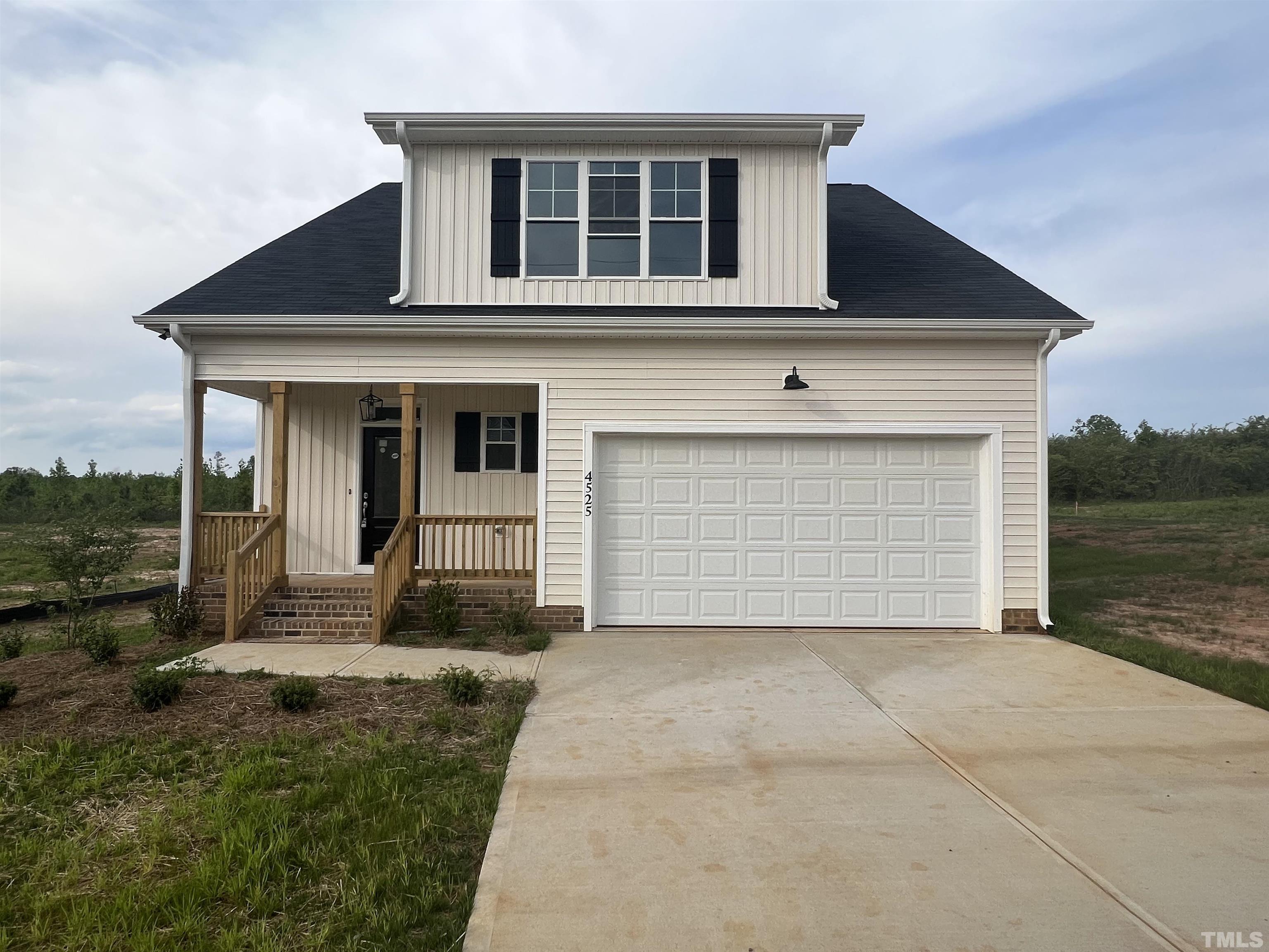 4525 Debnam Road Zebulon, NC 27597 - Photo 1 of 10 a front view of a house with a yard and garage