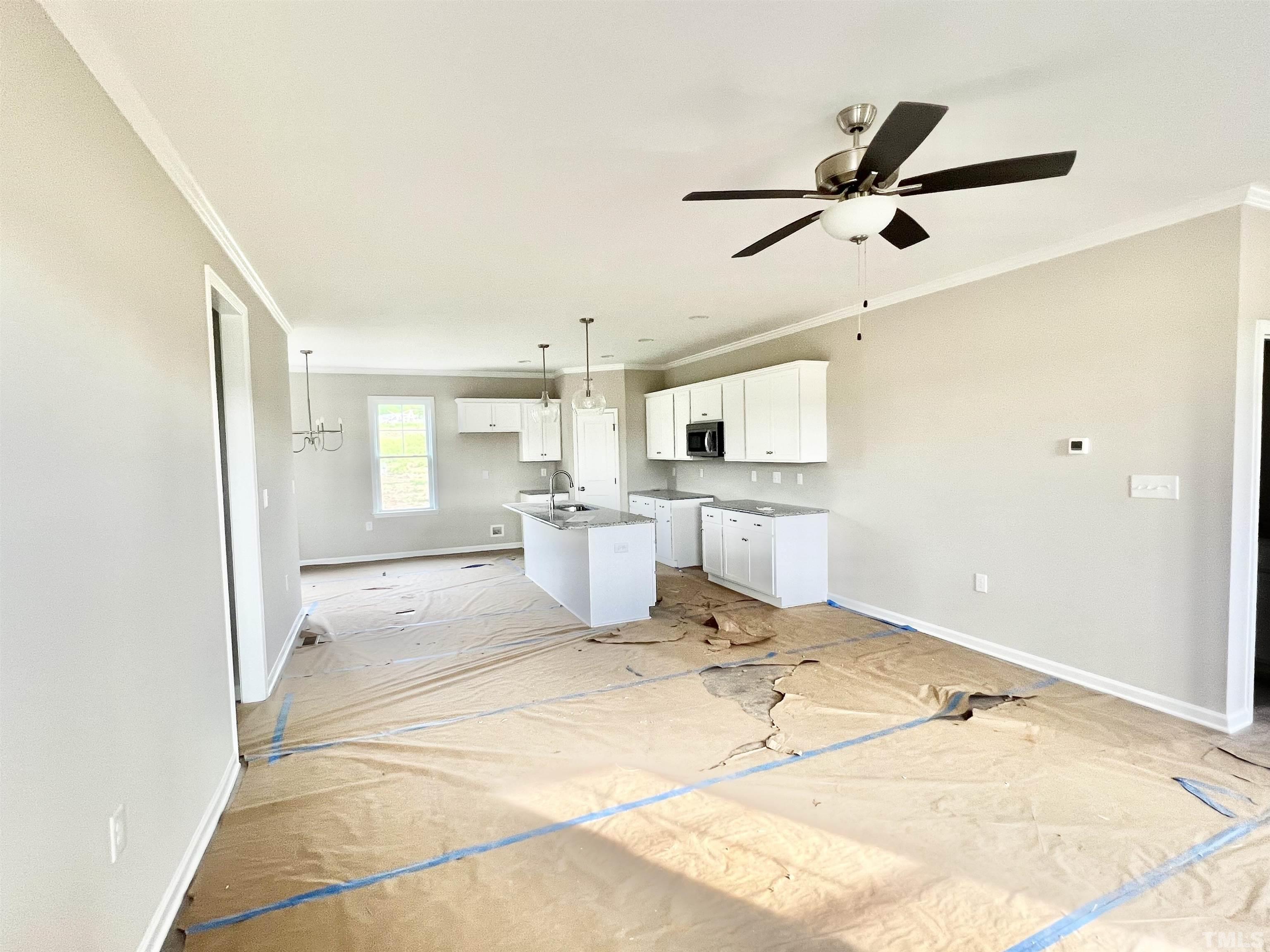 4525 Debnam Road Zebulon, NC 27597 - Photo 4 of 10 a room with a ceiling fan and a window